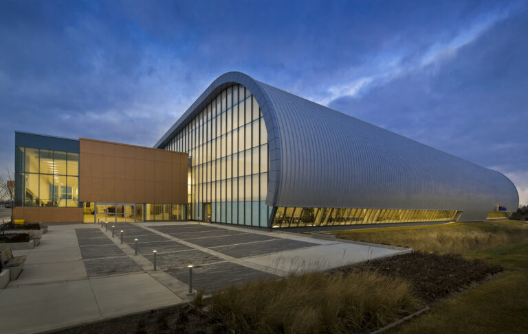 The exterior of the Jim Flaherty Field House at Abilities Centre at dusk.