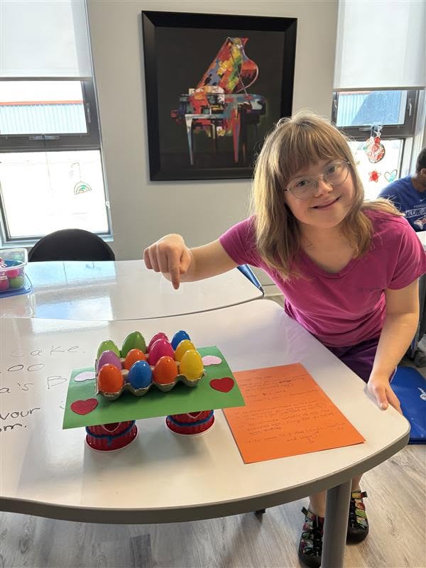 A program participant showing off their newly painted eggs.