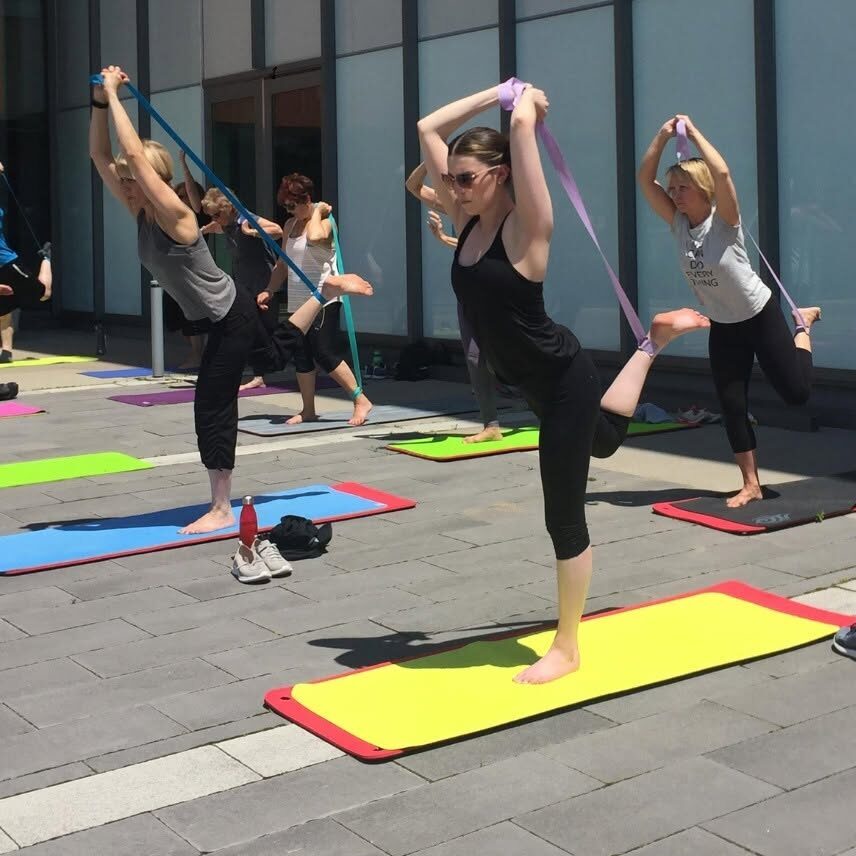 People participating in an outdoor yoga session.